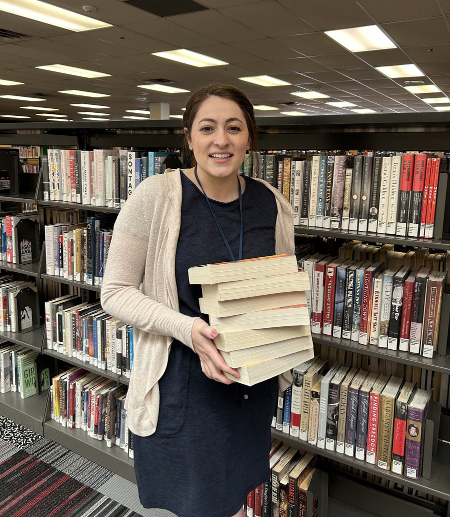 LIbrarian Holding a Stack of Books