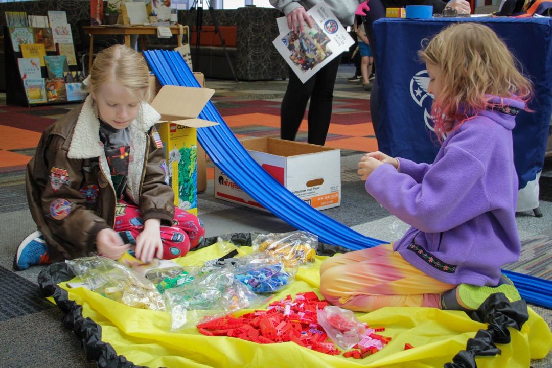 Kids Playing with Legos on the ground within the library