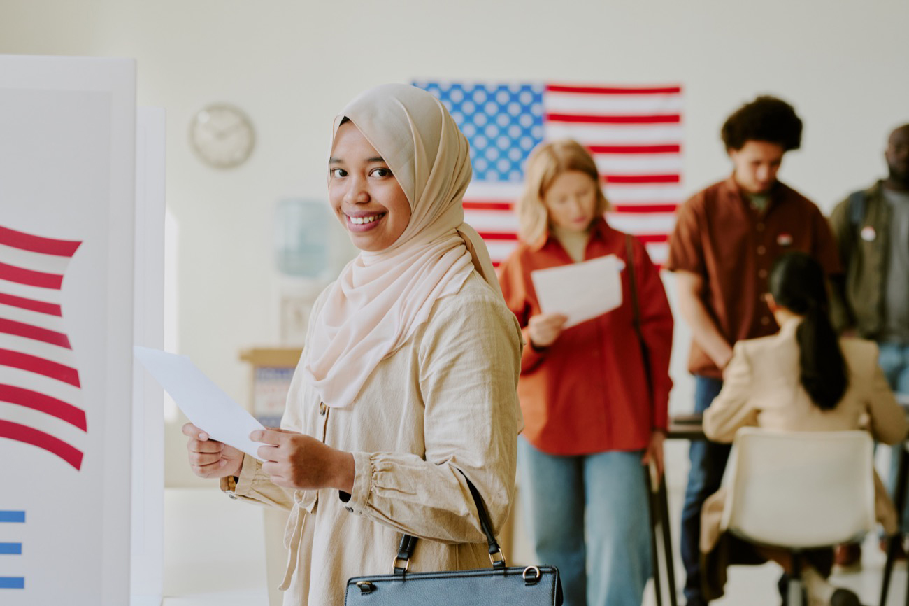 Cheerful Muslim woman with piece of paper in her hand