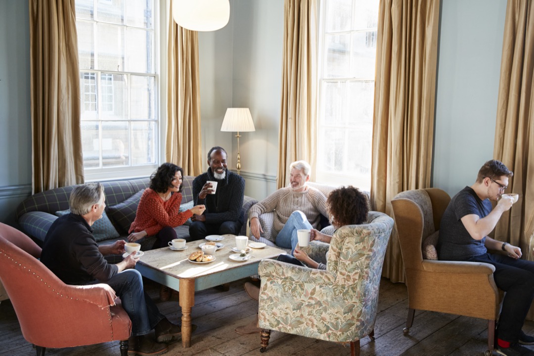 Group of middle aged friends meeting around table